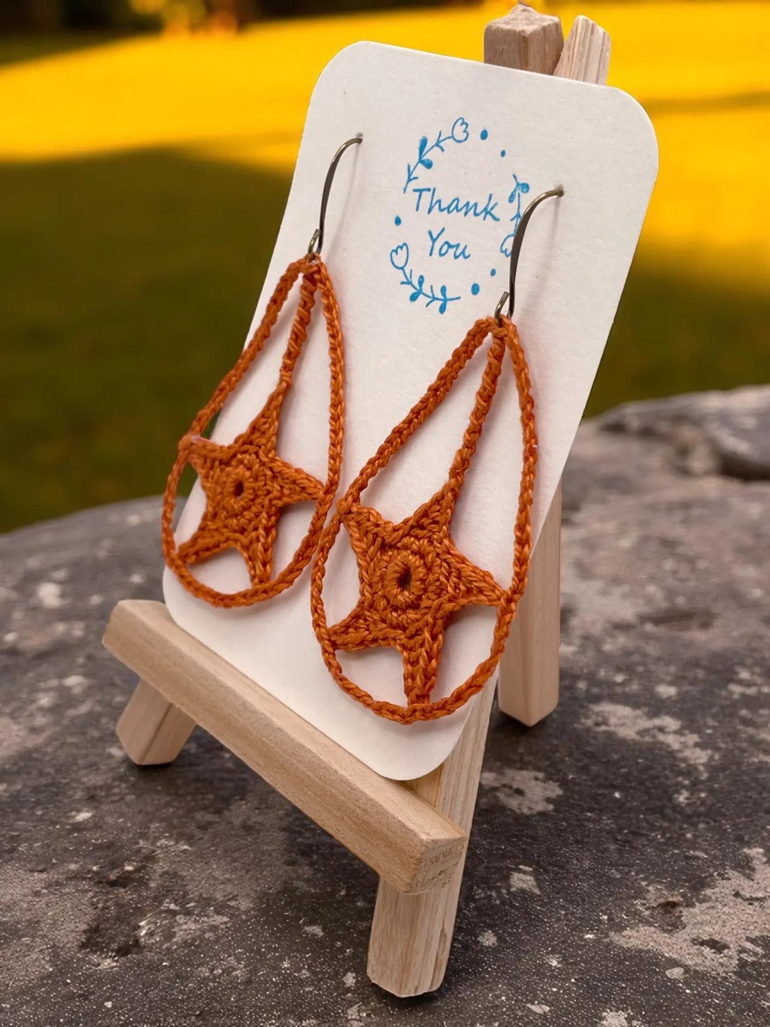 Dangling star in burnt orange Tangles & Twine