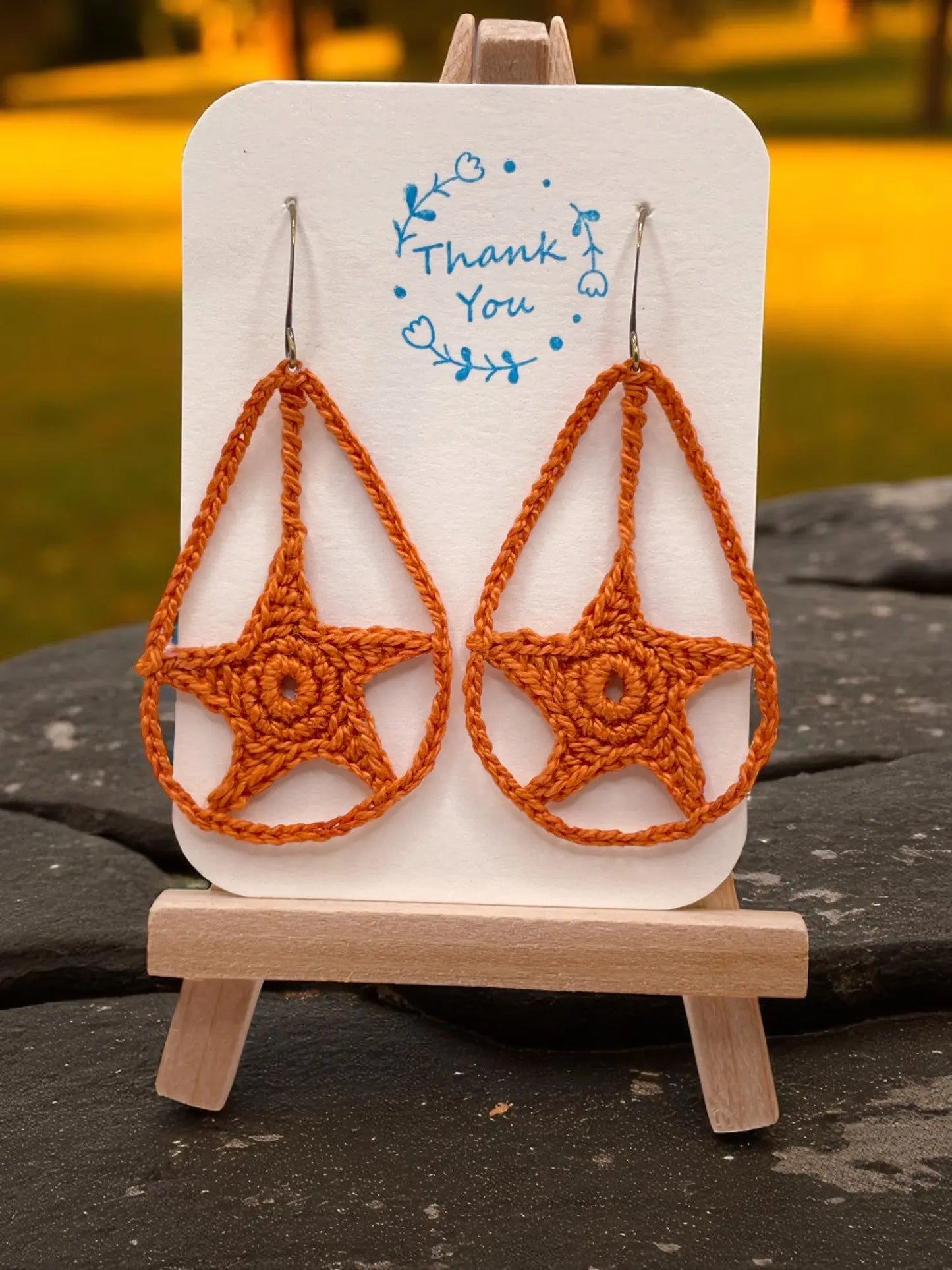 Dangling star in burnt orange Tangles & Twine