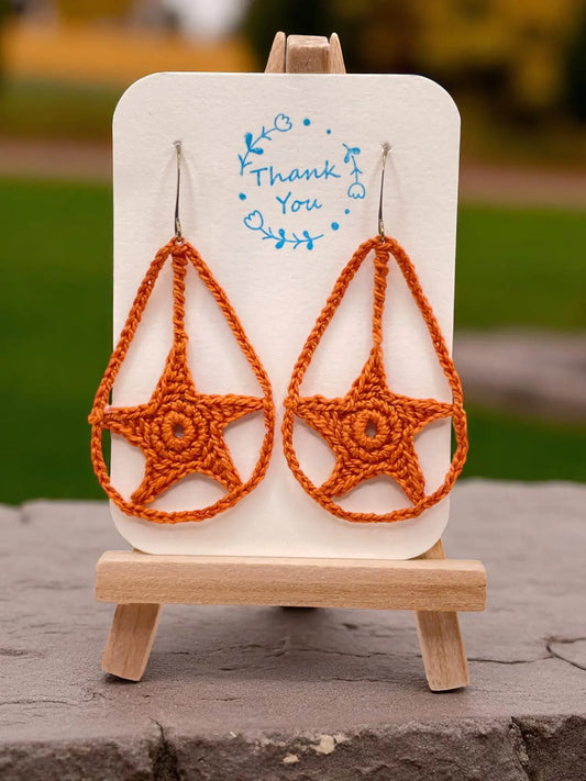 Dangling star in burnt orange Tangles & Twine